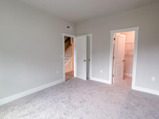 207 Pond View Ct Unit 3, Fuquay Varina, NC 27526 - unfurnished bedroom featuring carpet flooring, a spacious closet, baseboards, and a closet