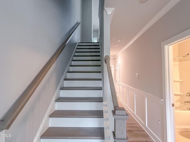 207 Pond View Ct Unit 3, Fuquay Varina, NC 27526 - staircase featuring a wainscoted wall, a decorative wall, crown molding, and wood finished floors
