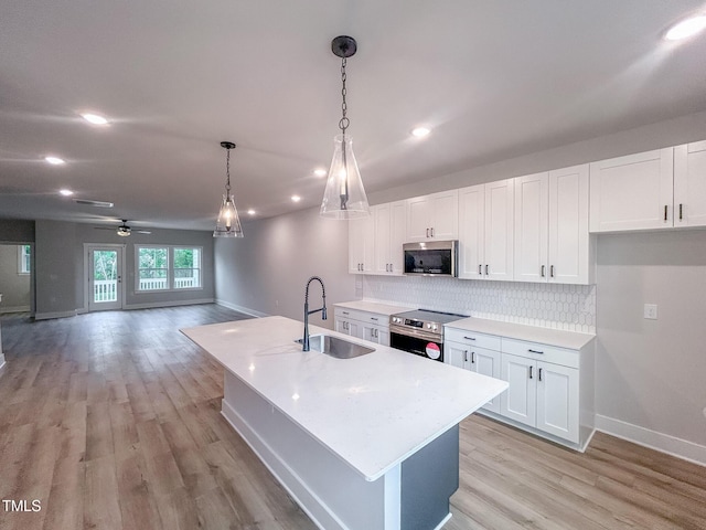 207 Pond View Ct Unit 3, Fuquay Varina, NC 27526 - kitchen featuring appliances with stainless steel finishes, a sink, baseboards, white cabinets, and recessed lighting