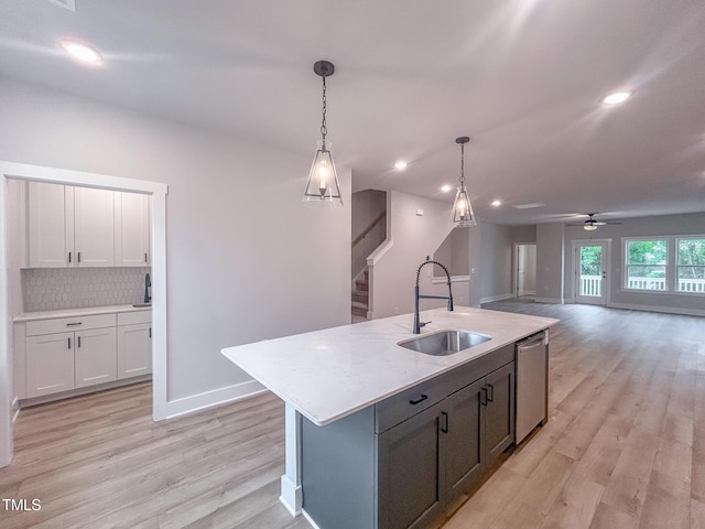 207 Pond View Ct Unit 3, Fuquay Varina, NC 27526 - kitchen featuring dishwasher, a sink, light wood-style flooring, decorative light fixtures, and tasteful backsplash