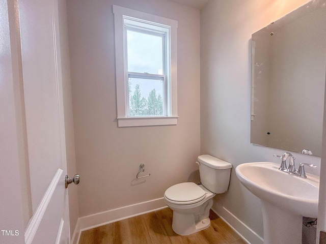 207 Pond View Ct Unit 3, Fuquay Varina, NC 27526 - half bathroom featuring toilet, baseboards, wood finished floors, and a sink