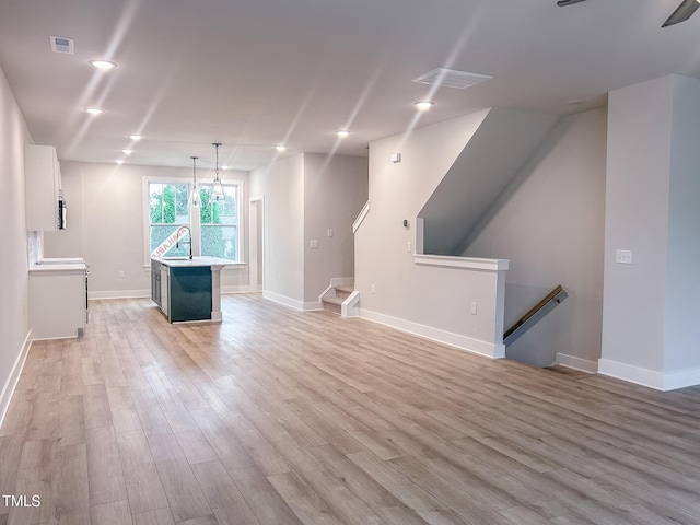 207 Pond View Ct Unit 3, Fuquay Varina, NC 27526 - unfurnished living room featuring light wood-style flooring, a sink, baseboards, and recessed lighting