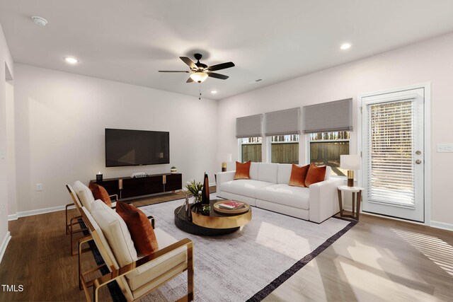 living room with hardwood / wood-style flooring and ceiling fan