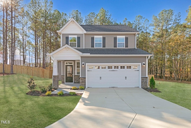 view of front of property featuring a garage and a front lawn