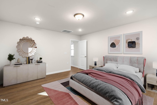 bedroom with dark hardwood / wood-style flooring