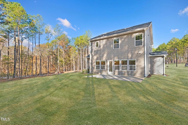 rear view of house with a lawn and a patio