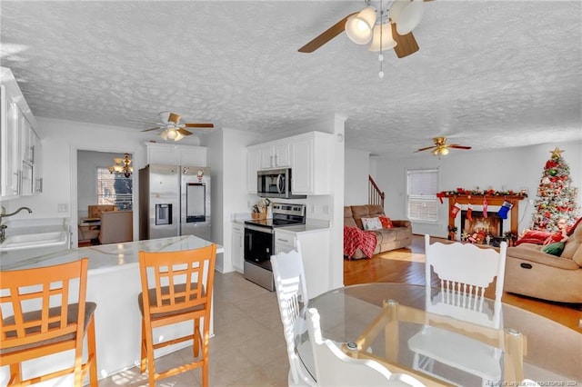 dining room featuring sink and a textured ceiling