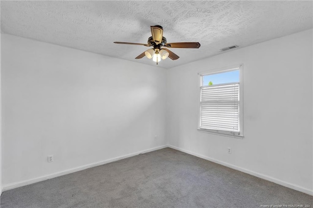 spare room featuring a textured ceiling, carpet floors, and ceiling fan