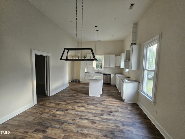 kitchen with a center island, high vaulted ceiling, white cabinetry, and a healthy amount of sunlight