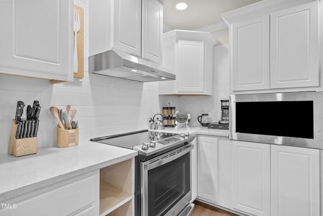 kitchen with decorative backsplash, white cabinetry, and appliances with stainless steel finishes