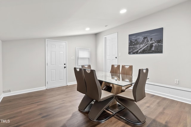 dining area with hardwood / wood-style flooring and lofted ceiling