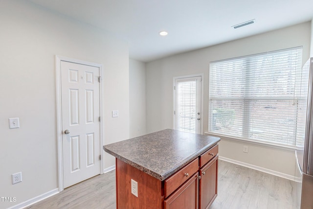 kitchen featuring a center island and light hardwood / wood-style flooring