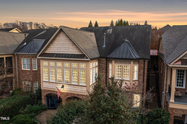 view of back house at dusk