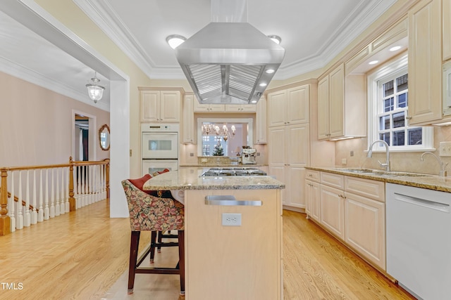 kitchen with light stone countertops, white appliances, light wood-type flooring, and ornamental molding