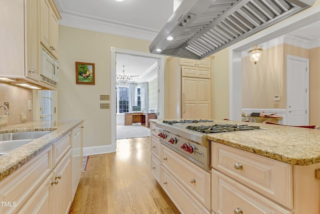 kitchen featuring island exhaust hood, light wood-type flooring, light stone counters, ornamental molding, and white appliances