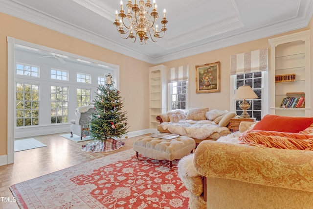 living room featuring hardwood / wood-style floors, built in shelves, and crown molding