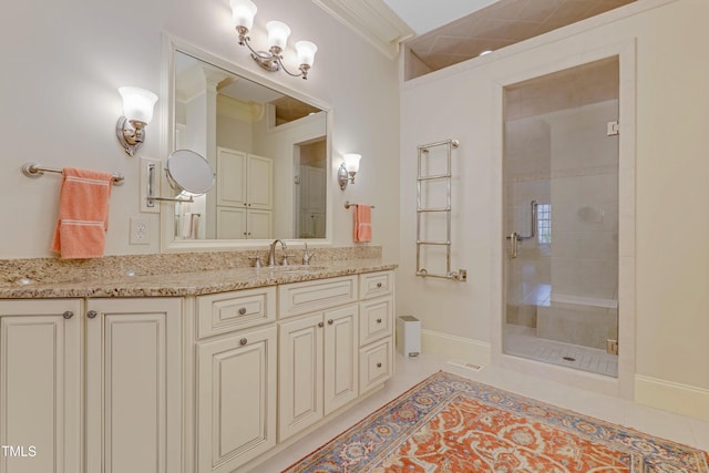 bathroom featuring tile patterned flooring, vanity, a shower with door, and ornamental molding