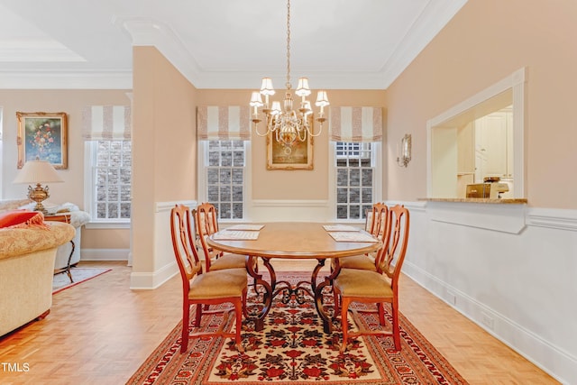 dining area with crown molding, parquet floors, and an inviting chandelier