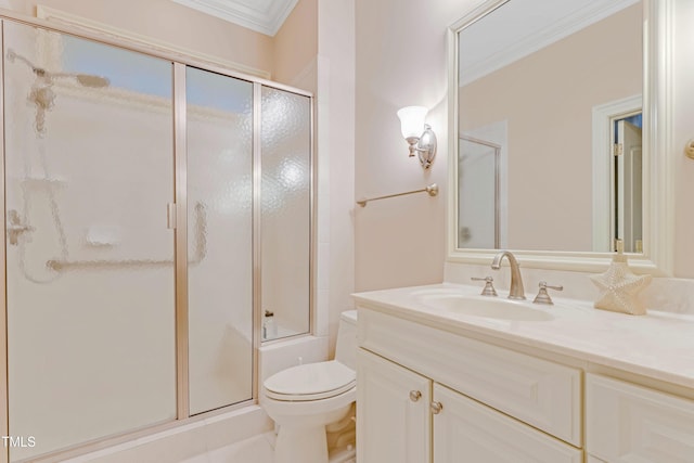 bathroom with vanity, toilet, and ornamental molding