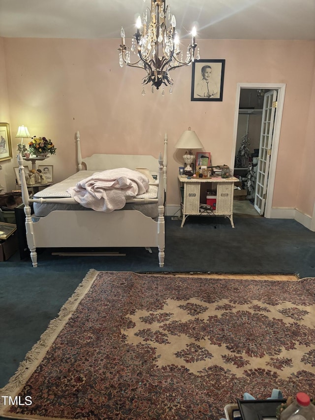 bedroom with dark carpet and a notable chandelier