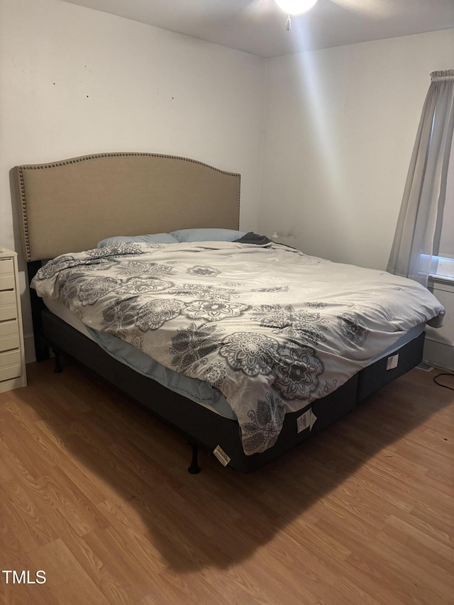 bedroom with wood-type flooring