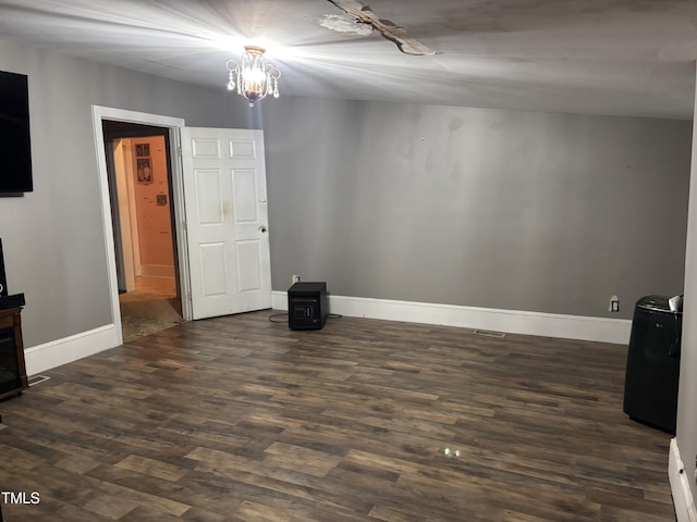 unfurnished room with dark hardwood / wood-style floors and a chandelier