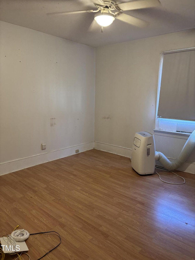 empty room with hardwood / wood-style flooring and ceiling fan