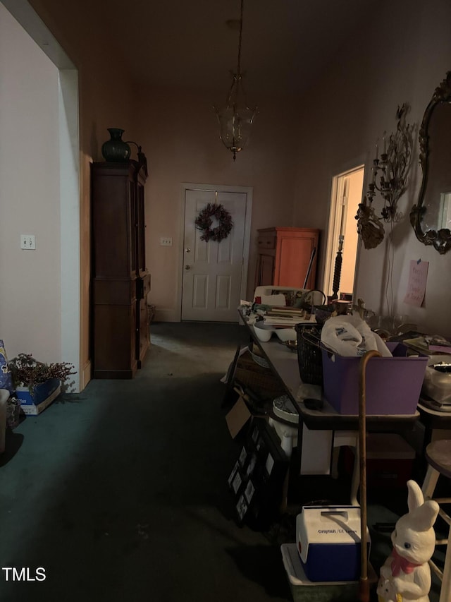 interior space featuring carpet floors and an inviting chandelier