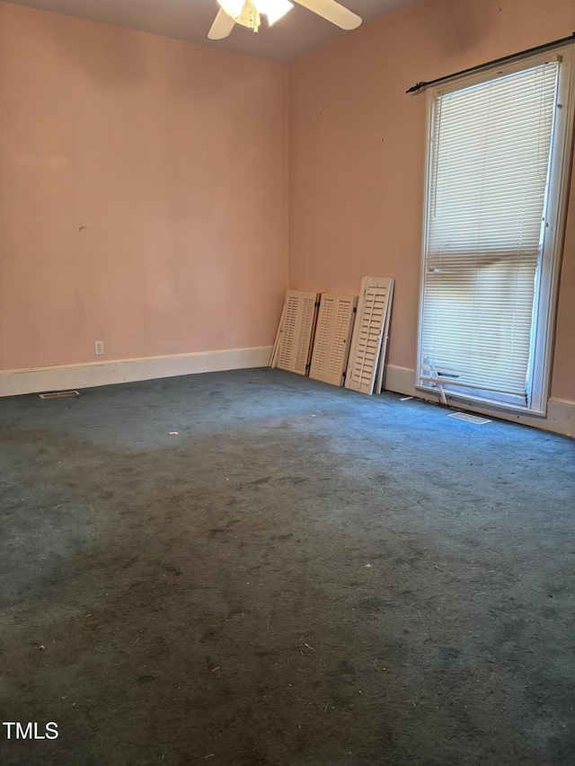 spare room featuring carpet floors and ceiling fan