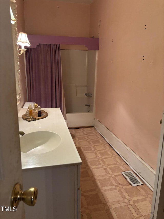 bathroom featuring shower / tub combination and vanity