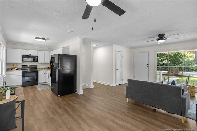 living room featuring ceiling fan, crown molding, a textured ceiling, and light hardwood / wood-style flooring