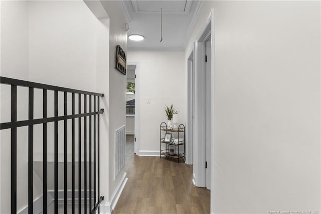 hall with hardwood / wood-style flooring and crown molding