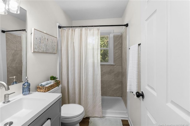 bathroom with vanity, toilet, and walk in shower