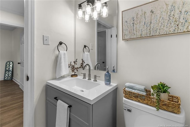 bathroom featuring vanity, hardwood / wood-style flooring, and toilet