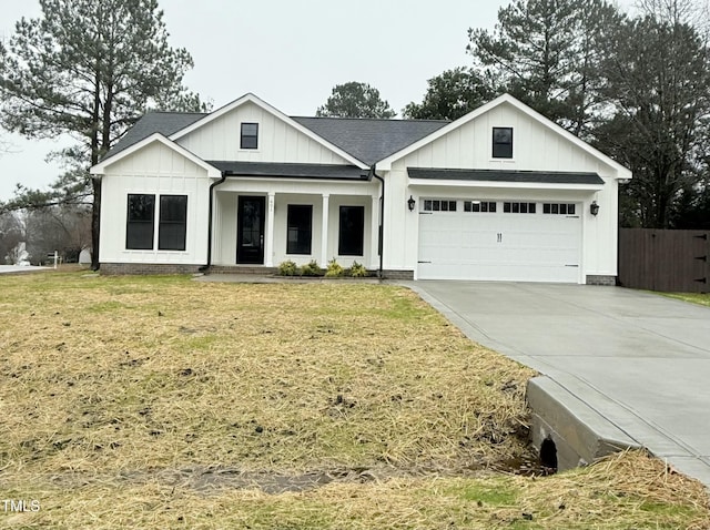 modern inspired farmhouse with a garage and a front yard