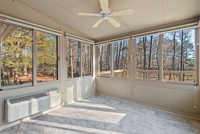 unfurnished sunroom featuring lofted ceiling, ceiling fan, and a wall mounted AC