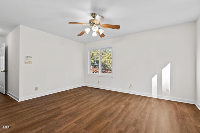 spare room with a ceiling fan, baseboards, and wood finished floors