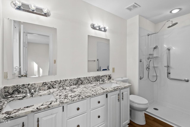 full bathroom with toilet, visible vents, a shower, and a sink