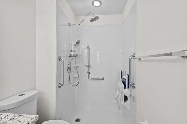 bathroom featuring toilet and walk in shower