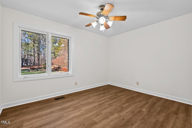 unfurnished room with visible vents, baseboards, ceiling fan, and wood finished floors