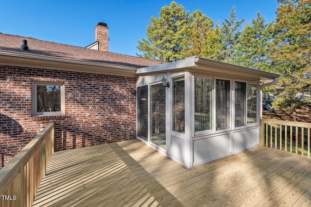 wooden deck with a sunroom