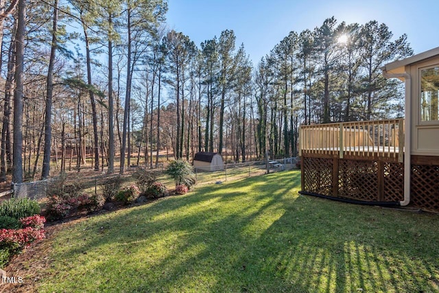 view of yard with fence and a wooden deck