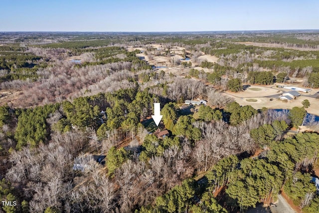 birds eye view of property featuring a wooded view