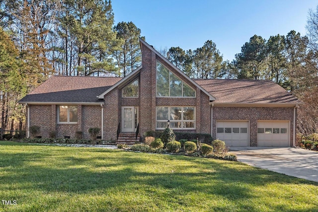 view of front facade with brick siding, a chimney, concrete driveway, a front yard, and a garage