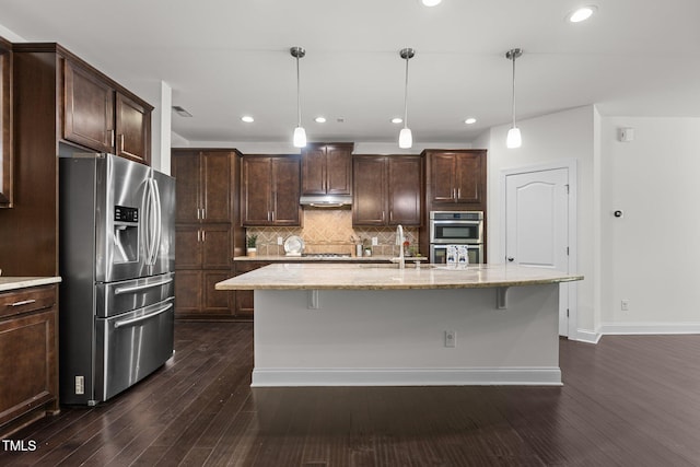 kitchen with decorative light fixtures, stainless steel appliances, dark hardwood / wood-style floors, and an island with sink