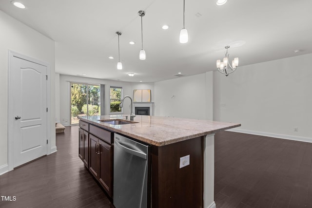 kitchen featuring pendant lighting, sink, stainless steel dishwasher, an island with sink, and dark hardwood / wood-style flooring