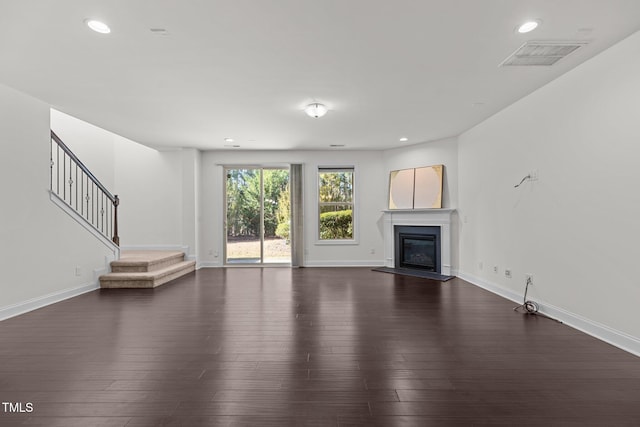 unfurnished living room with dark wood-type flooring