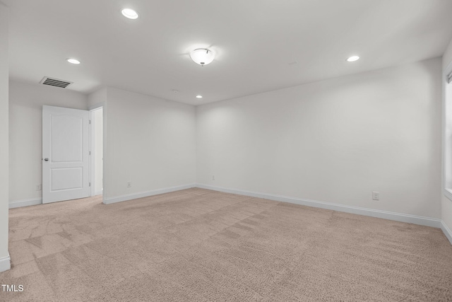 spare room featuring light colored carpet