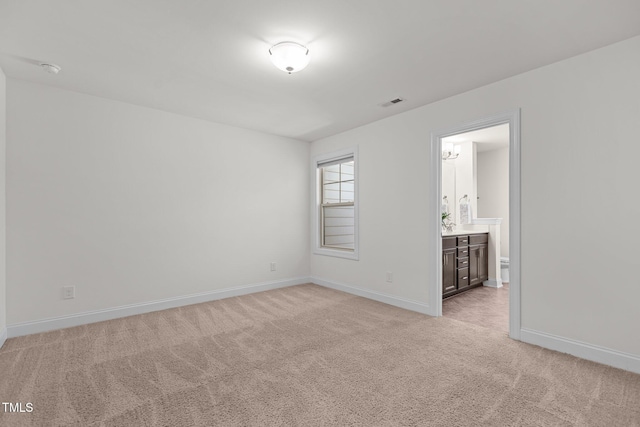 unfurnished room featuring light colored carpet