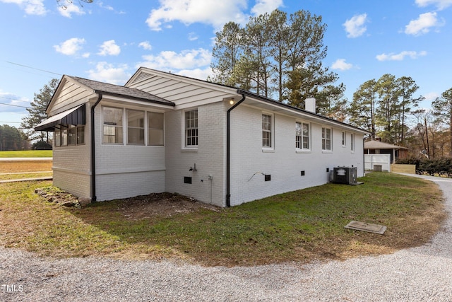 view of property exterior featuring cooling unit and a lawn